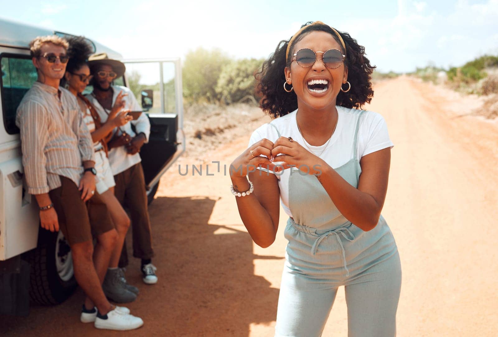 Heart, hands and black woman with love for road trip with friends in the countryside of California. Portrait of an African girl on safari holiday with people with support for adventure in the desert.