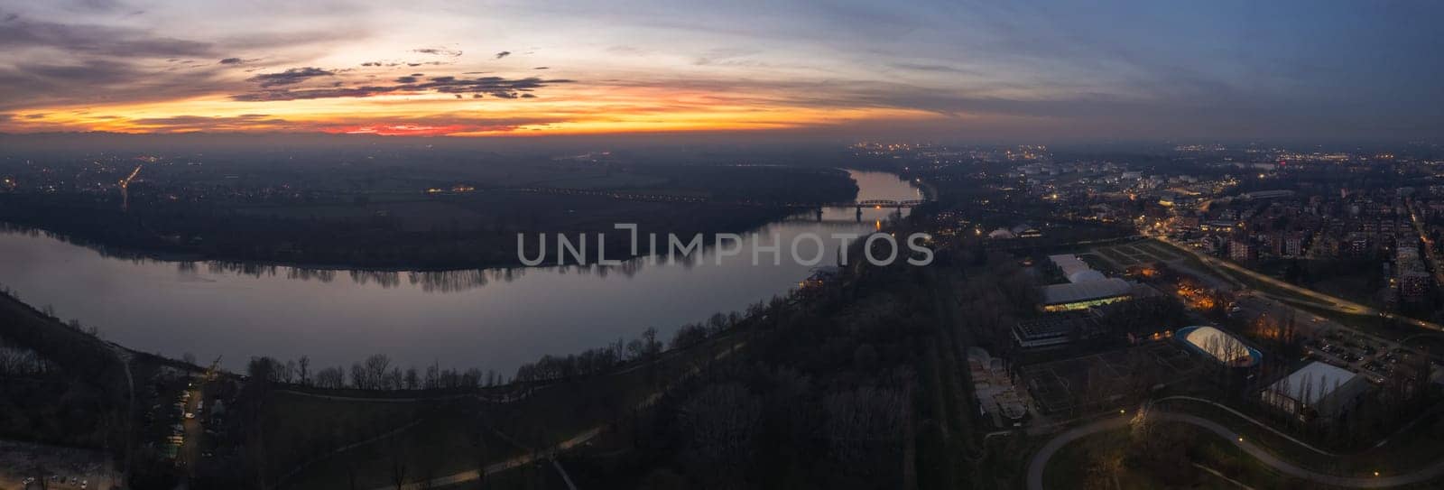 sunset time drone shot in Cremona, Lombardy, Italy in winter in Padain plain, river Po by verbano