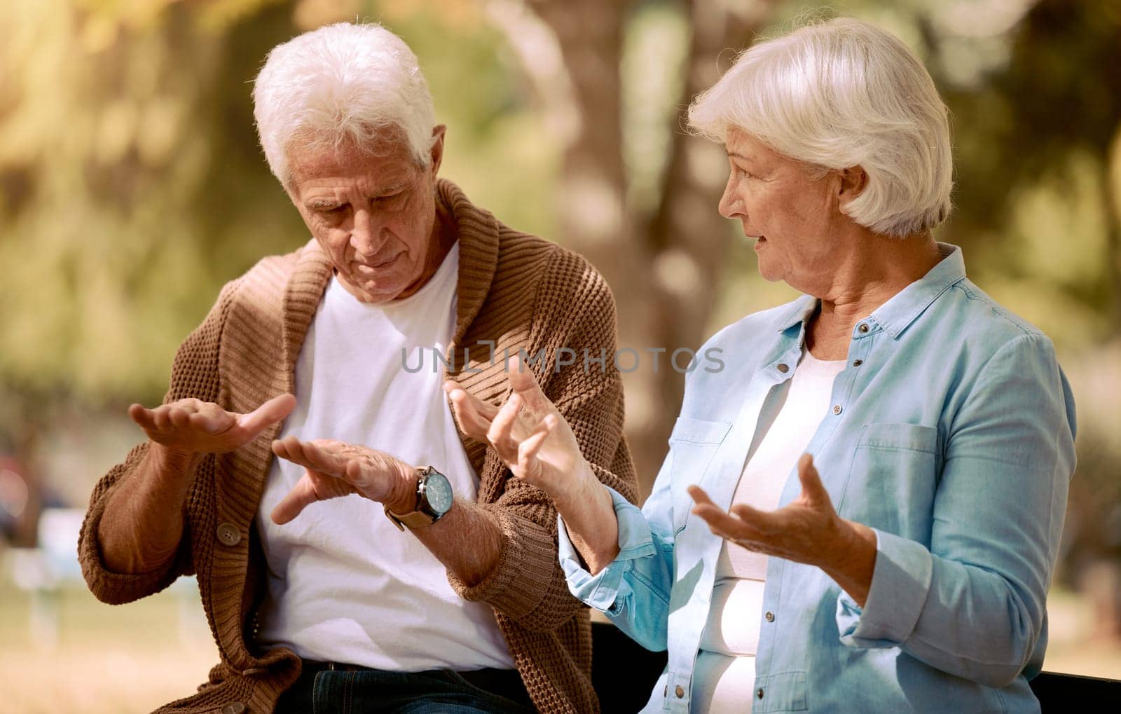 Senior couple, love and hands in sign language communication in nature, public park or garden. Retirement elderly, gesture or deaf disability in bonding date for man and woman in support conversation.