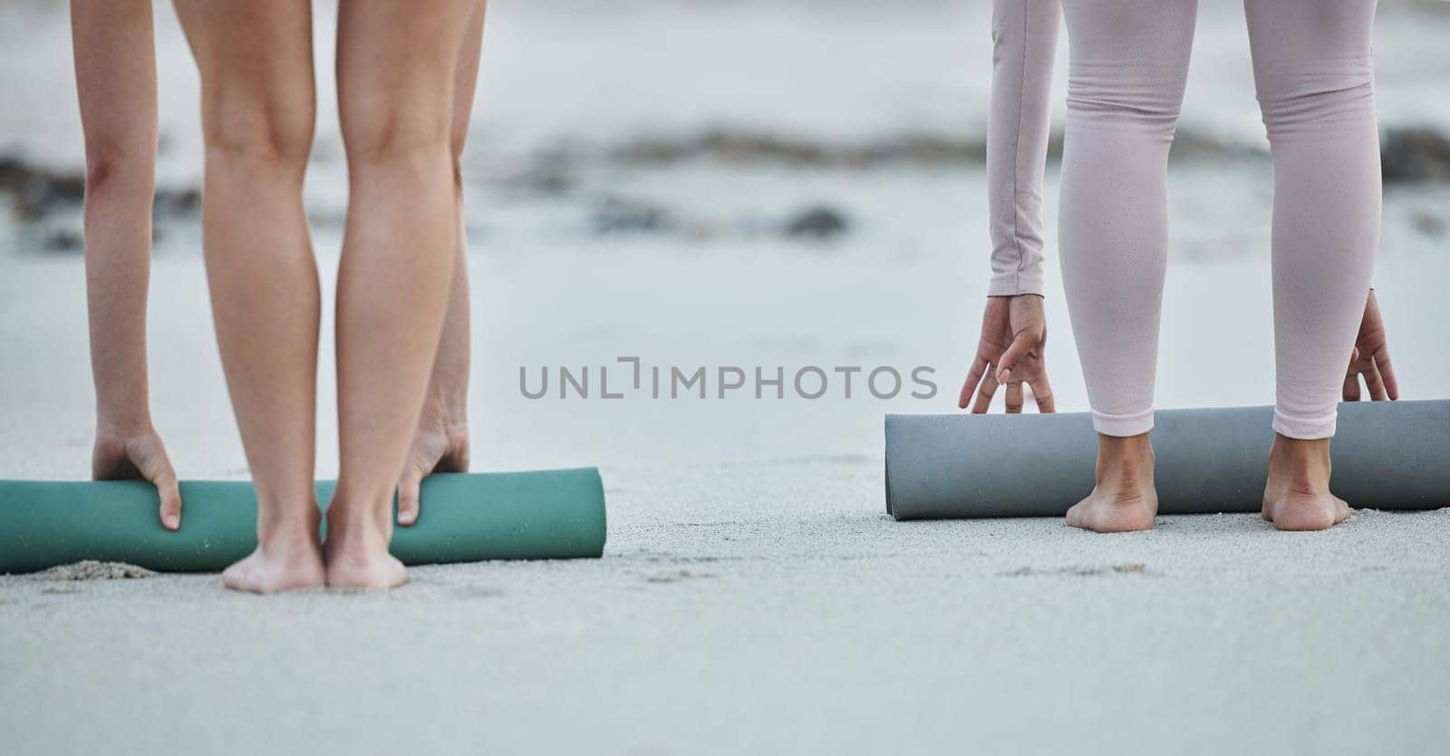 Yoga mat, women legs and beach sand after fitness exercise, workout and balance training for peace, zen and calm mindfulness. People together outdoor in nature for morning pilates wellness routine.