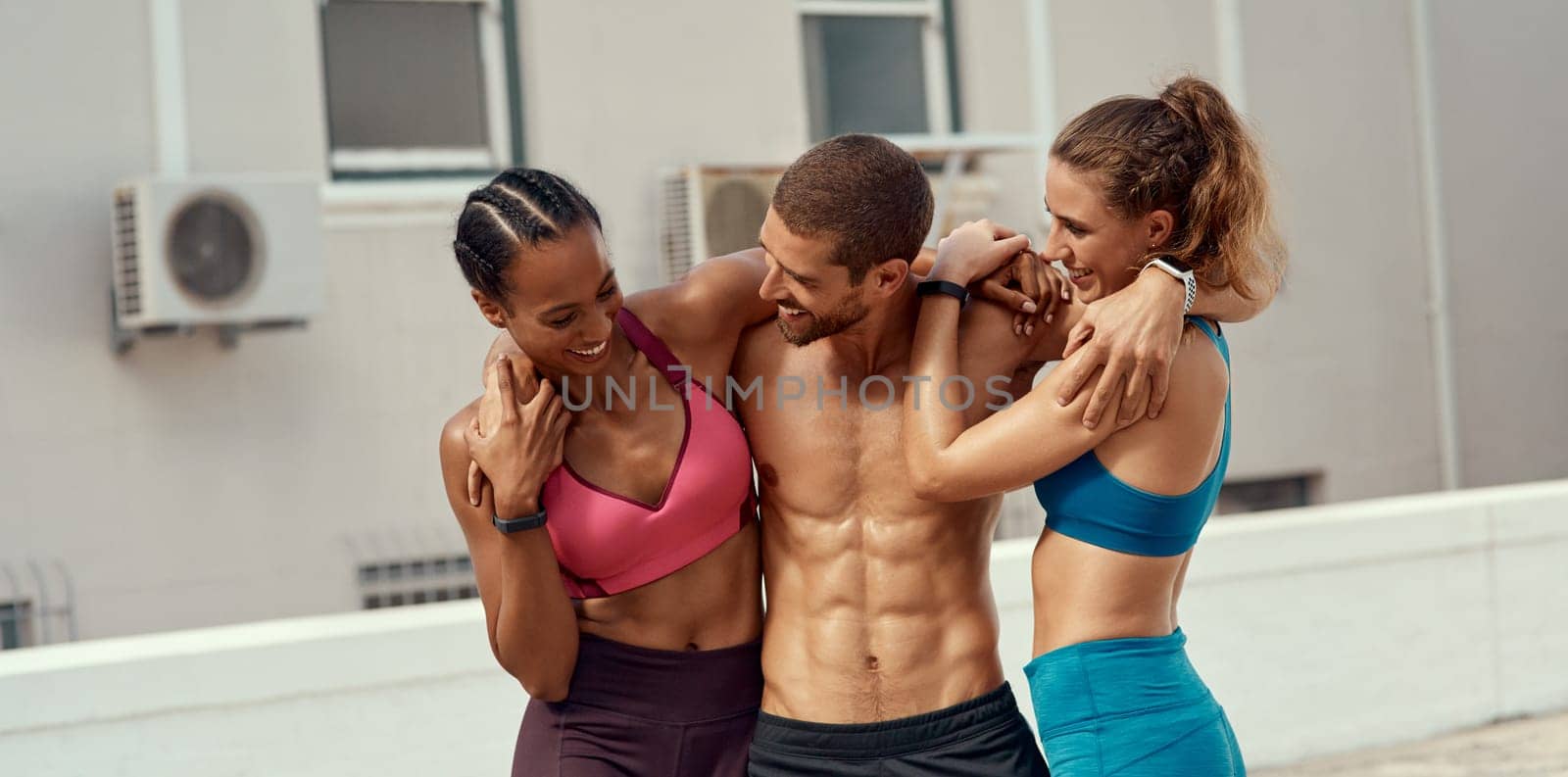 Now we know why working out together is better. a fitness group standing together while out for a workout. by YuriArcurs