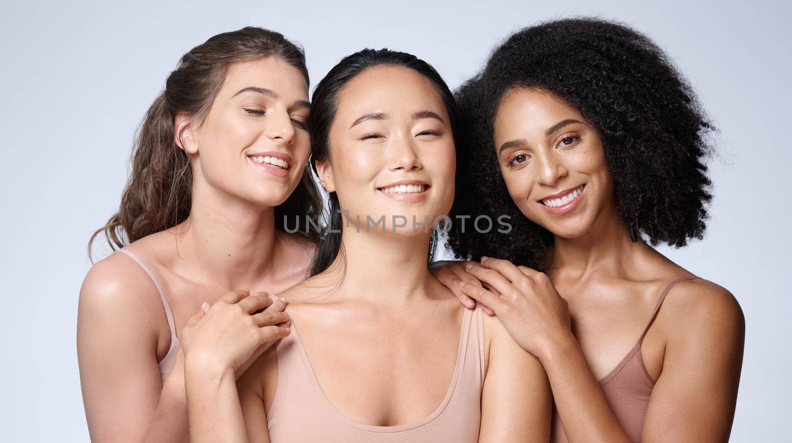 Women, faces diversity or skincare glow on studio background in healthcare wellness, self love empowerment or community support. Portrait, smile or happy beauty models or friends and makeup cosmetics.