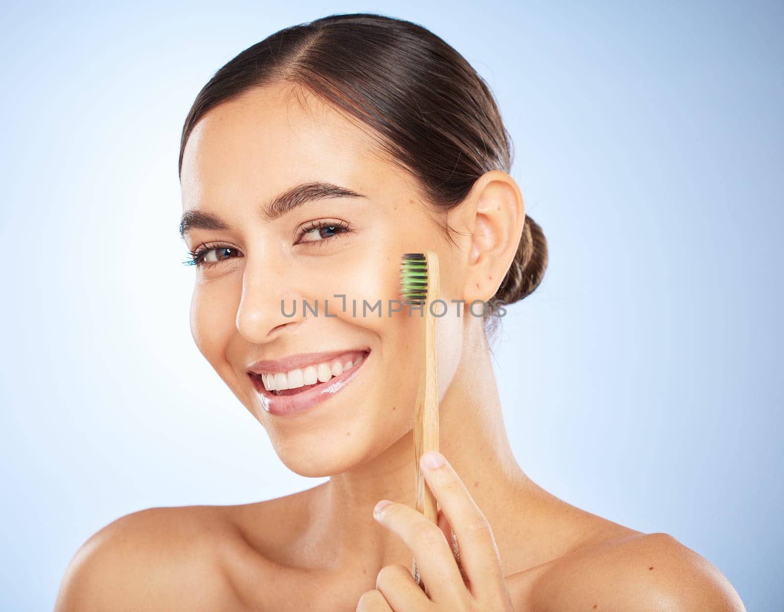 Face portrait, dental and woman with toothbrush in studio isolated on a blue background. Oral wellness, veneers and happy female model holding product for brushing teeth, cleaning and oral hygiene
