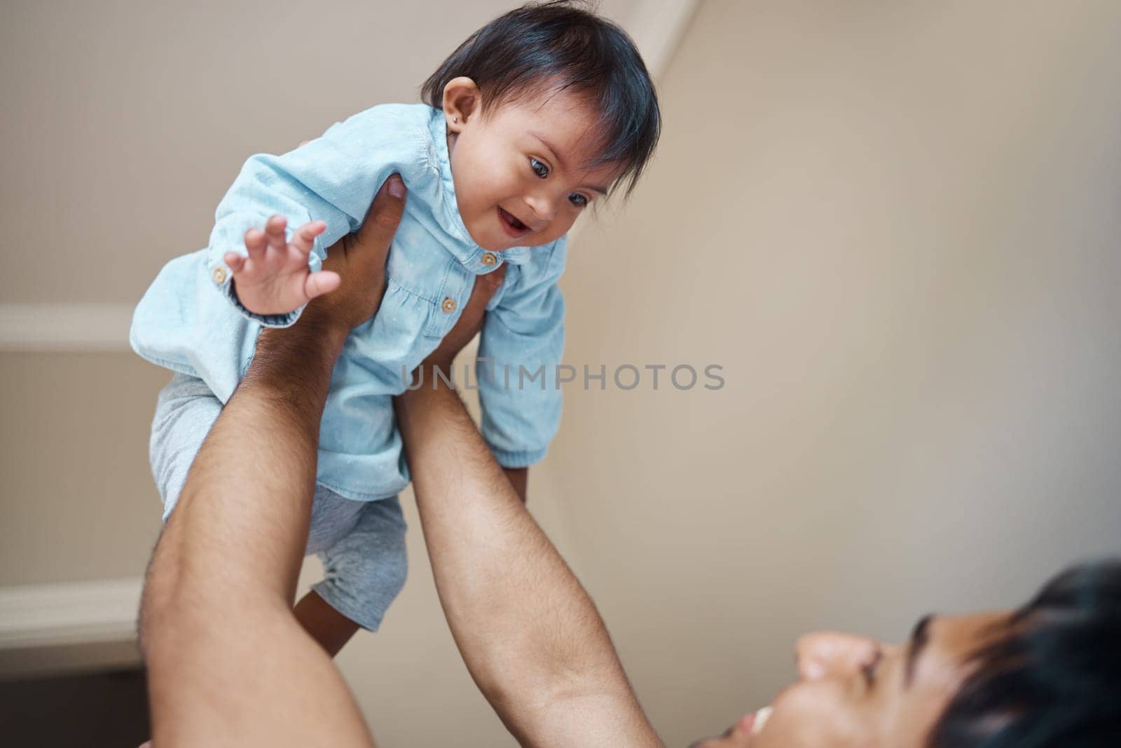 Down syndrome, baby and father with love for child, smile for care and happiness in their house. Newborn kid with disorder or condition happy, playing and laughing with dad as family in their home by YuriArcurs