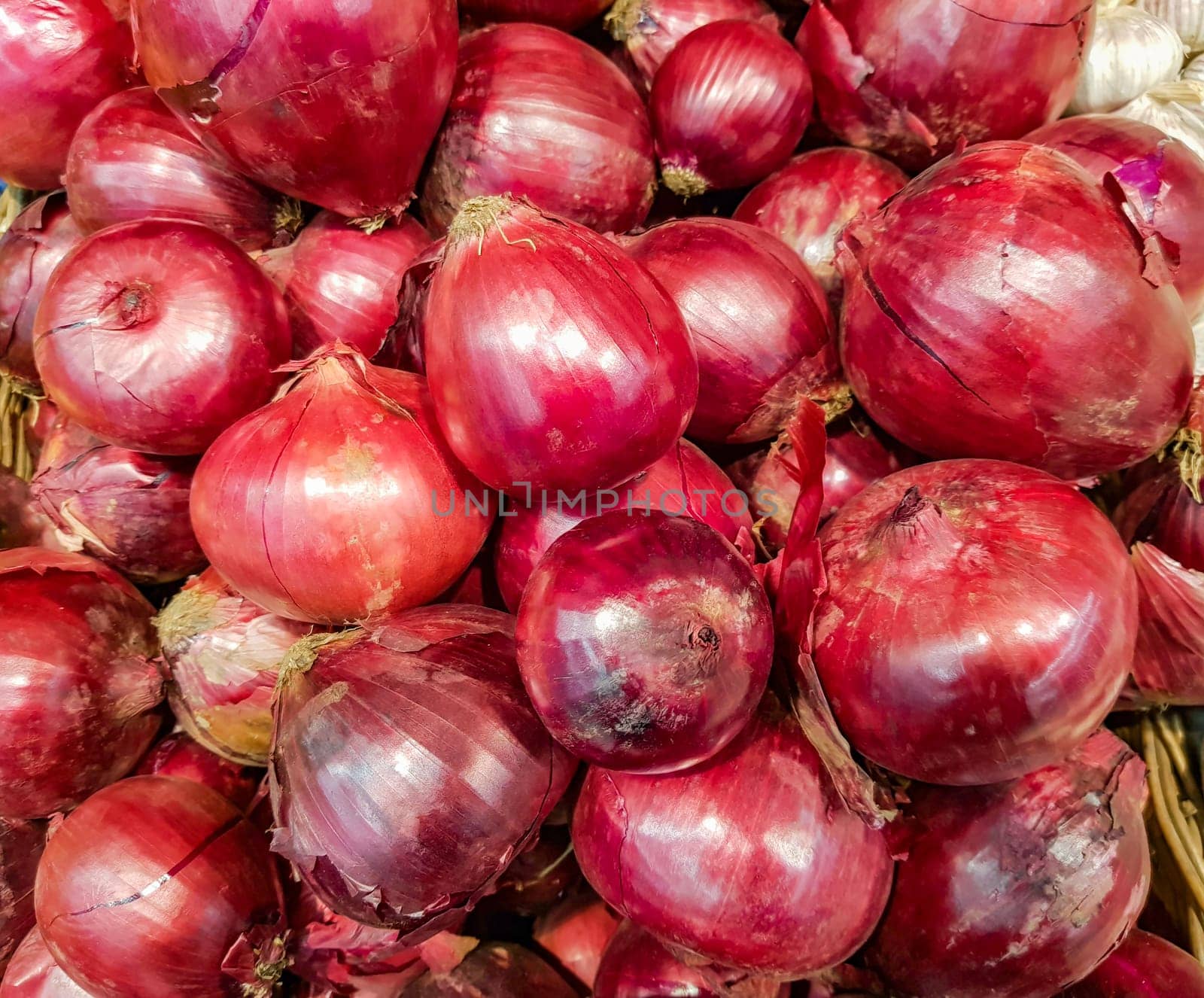 close-up of a lot of red onions, food background.