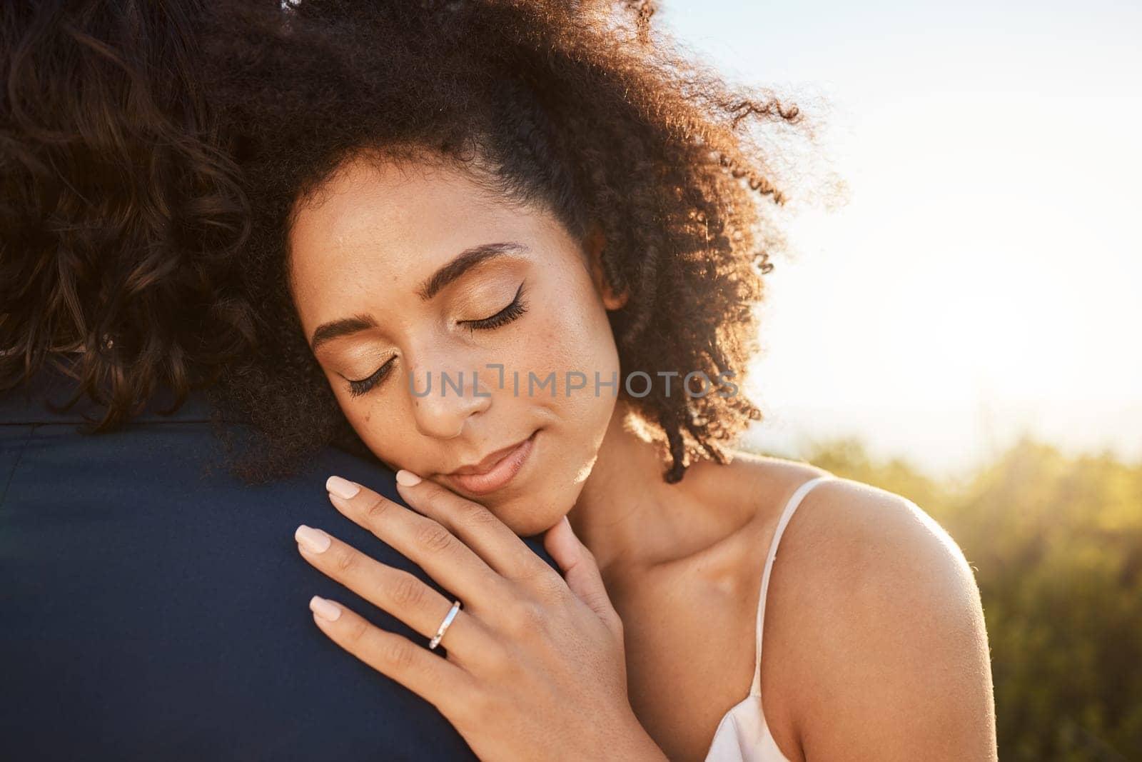 Wedding, bride and hug at sunset with embrace together for care, love and support in married life. Marriage of happy black woman hugging man in romance for commitment embracing relationship in nature.