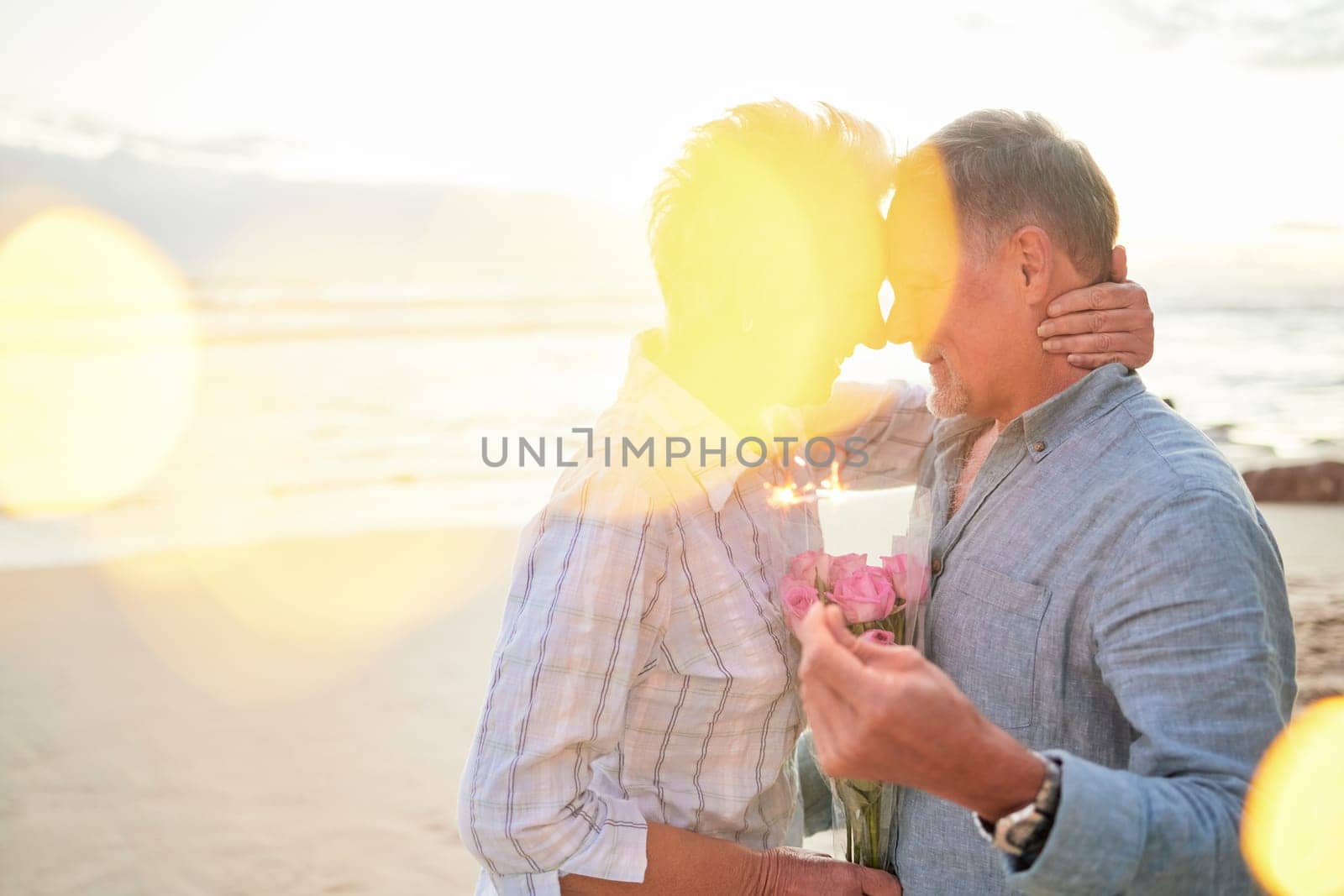 Flare, mockup and romance on the beach with an old couple outdoor in nature to celebrate valentines day. Summer, love or flowers with a senior man and woman celebrating on the coast together.