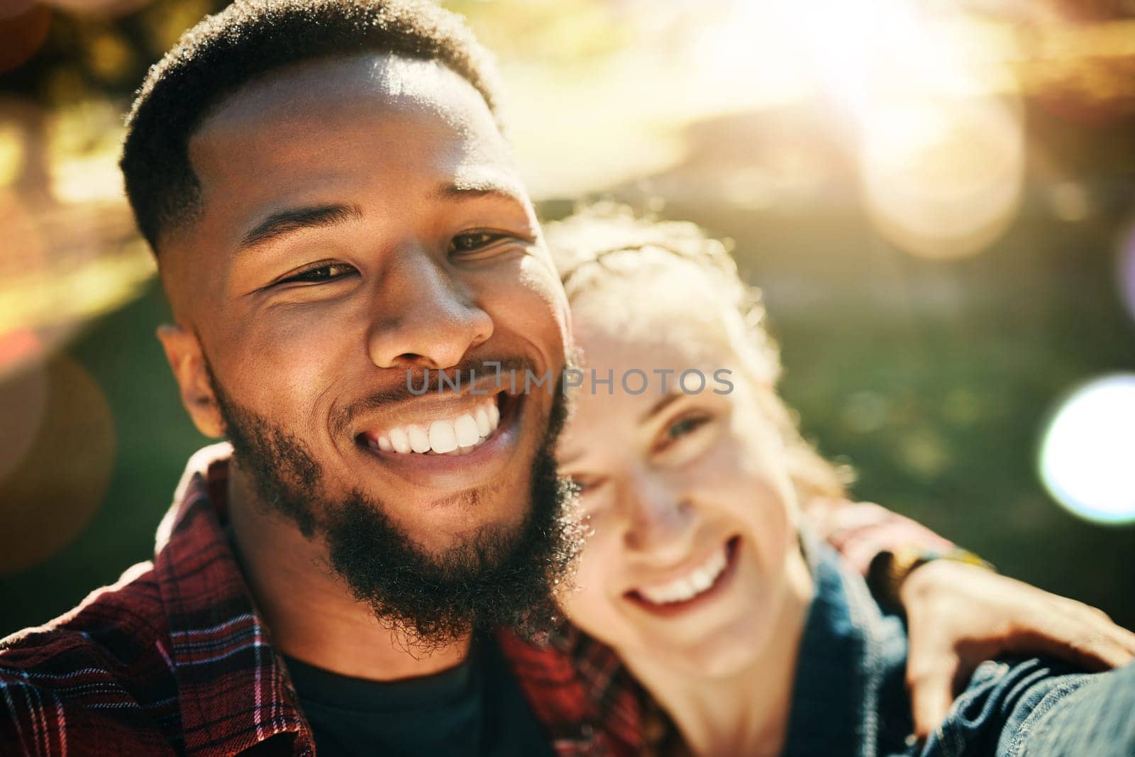 Couple, love selfie and portrait smile at park outdoors, enjoying fun time and bonding together. Diversity, romance and face of black man and woman taking pictures for happy memory or social media