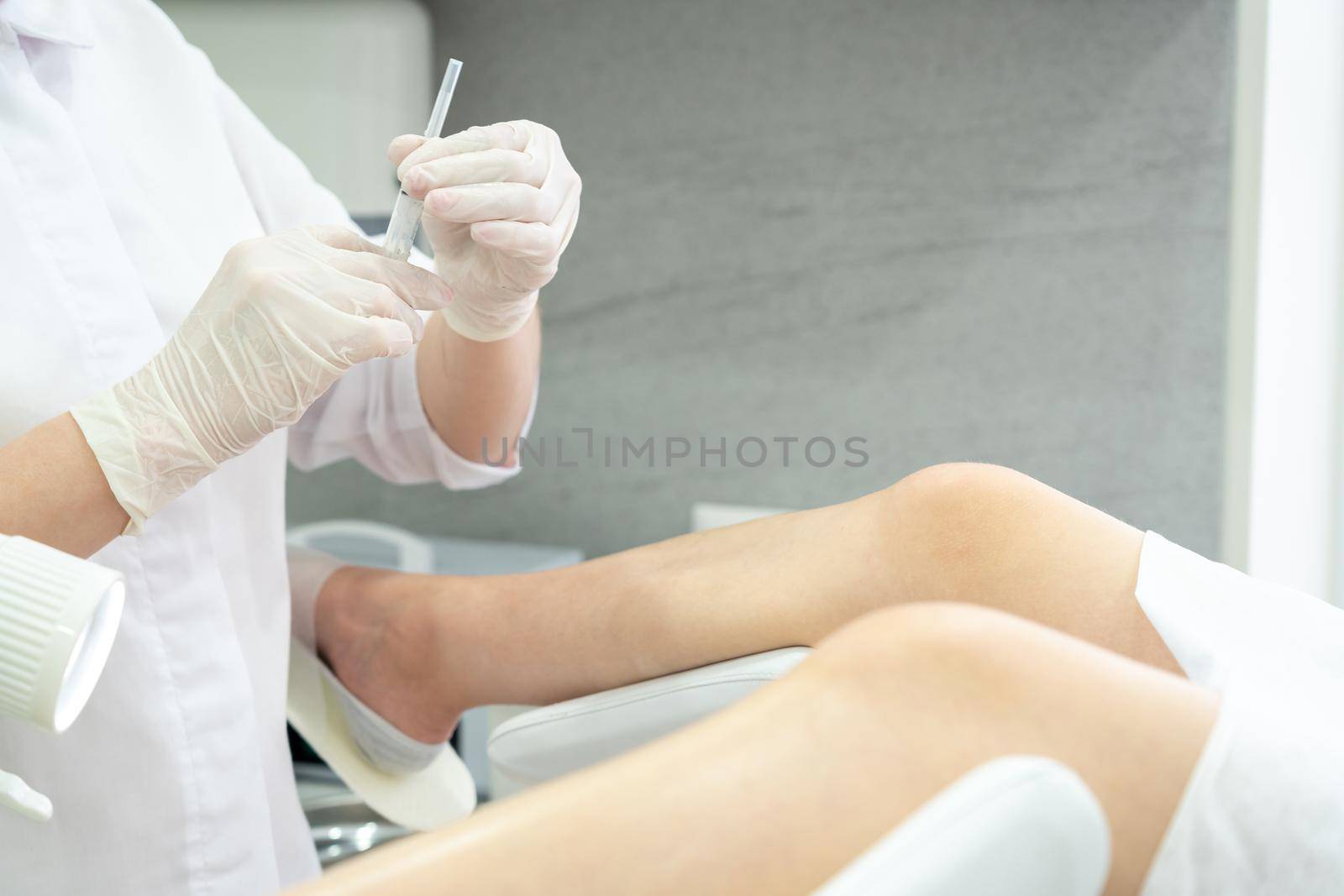 Gynecologist makes an injection. Attractive doctor gynecologist treats the patient