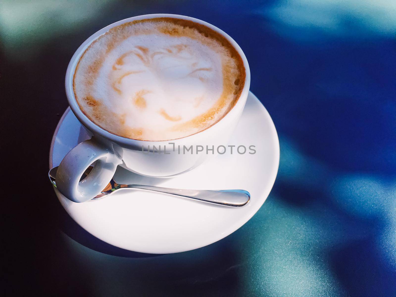 Cappuccino in summer cafe outdoors by Anneleven
