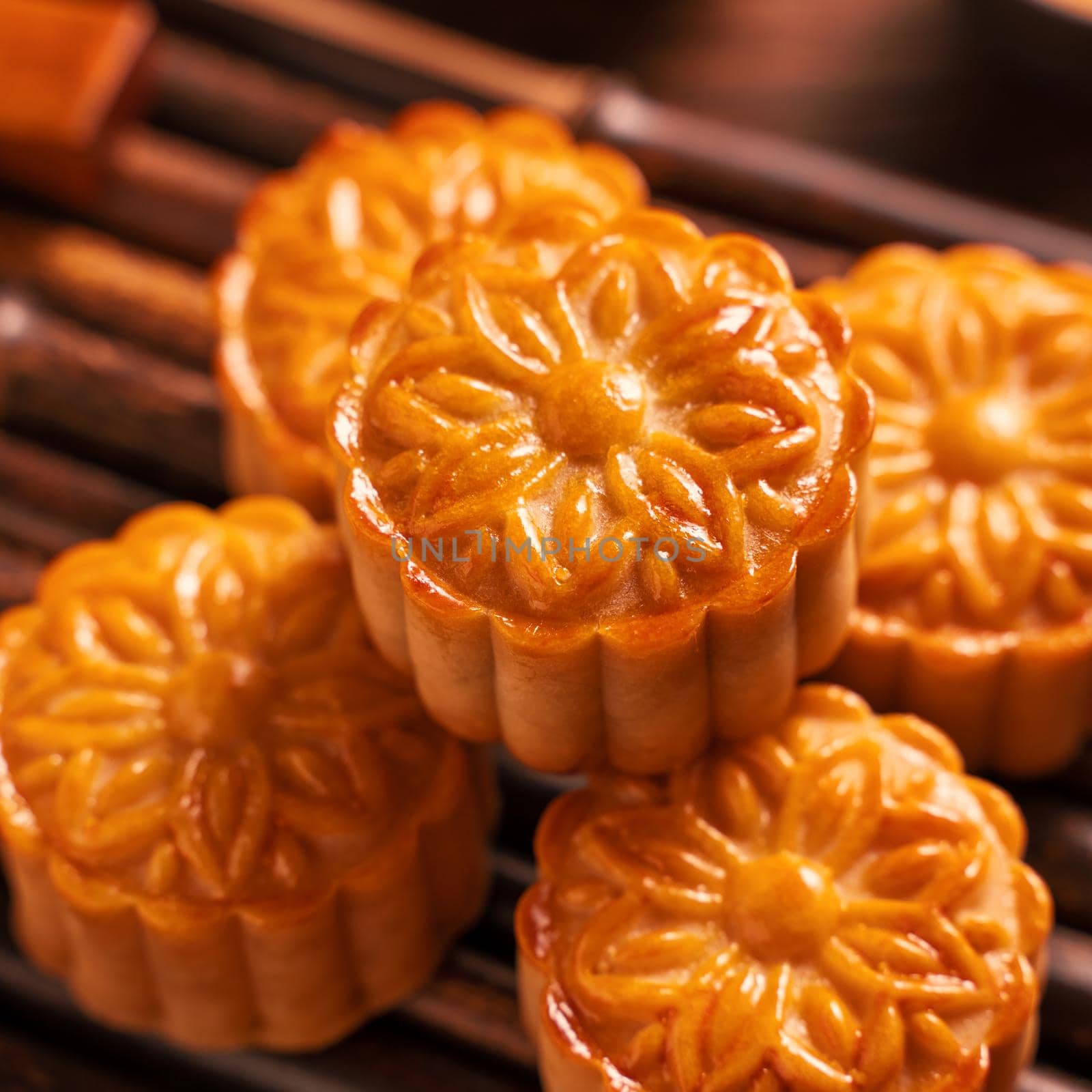 Moon cake Mooncake table setting - Round shaped Chinese traditional pastry with tea cups on wooden background, Mid-Autumn Festival concept, close up.