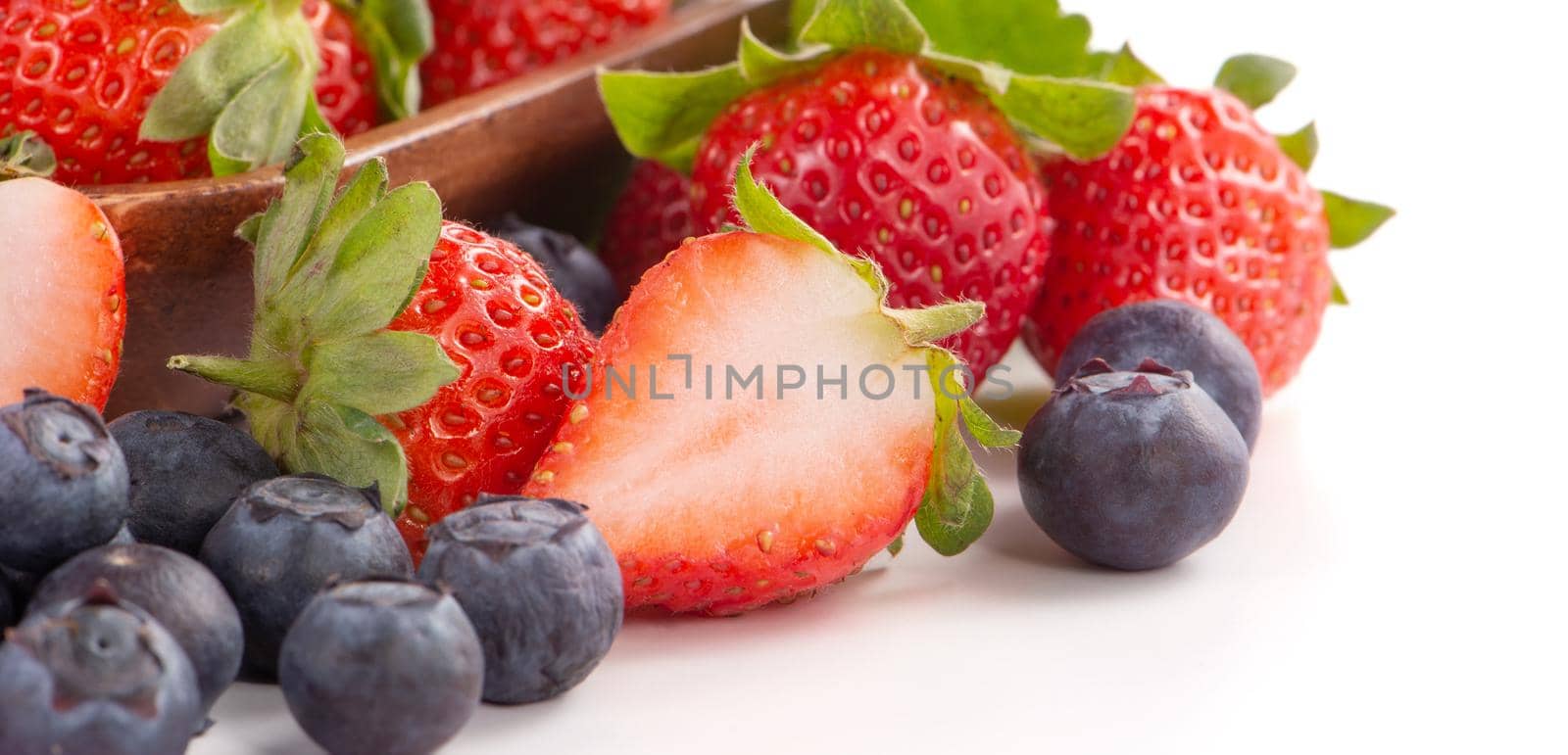 A bowl set of beautiful and delicious strawberry and blueberry isolated on white background, close up, copy space, clipping path, cut out.