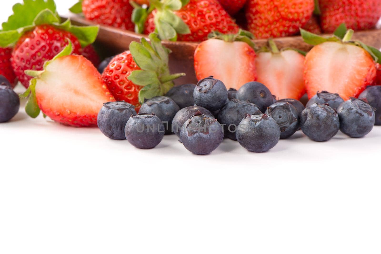 A bowl set of beautiful and delicious strawberry and blueberry isolated on white background, close up, copy space, clipping path, cut out.