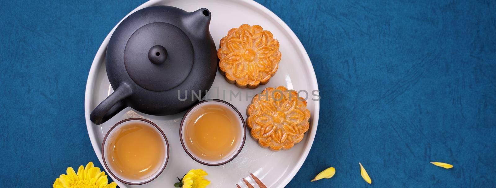 Minimal simplicity layout moon cakes on blue background for Mid-Autumn Festival, creative food design concept, top view, flat lay, copy space. by ROMIXIMAGE