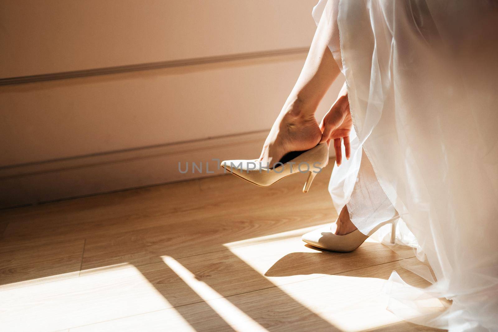 Bride taking off her shoes after wedding, romantic concept