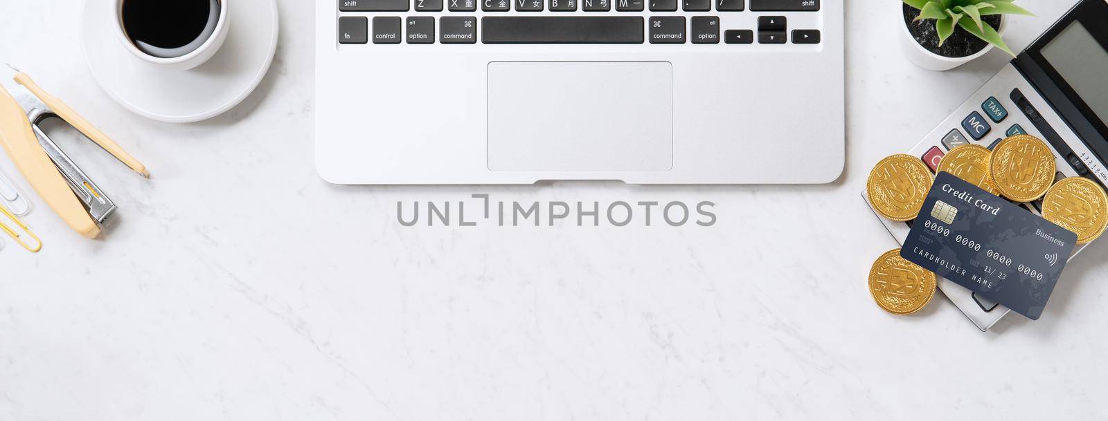 Concept of online payment with credit card with smart phone, laptop computer on office desk on clean bright marble table background, top view, flat lay by ROMIXIMAGE