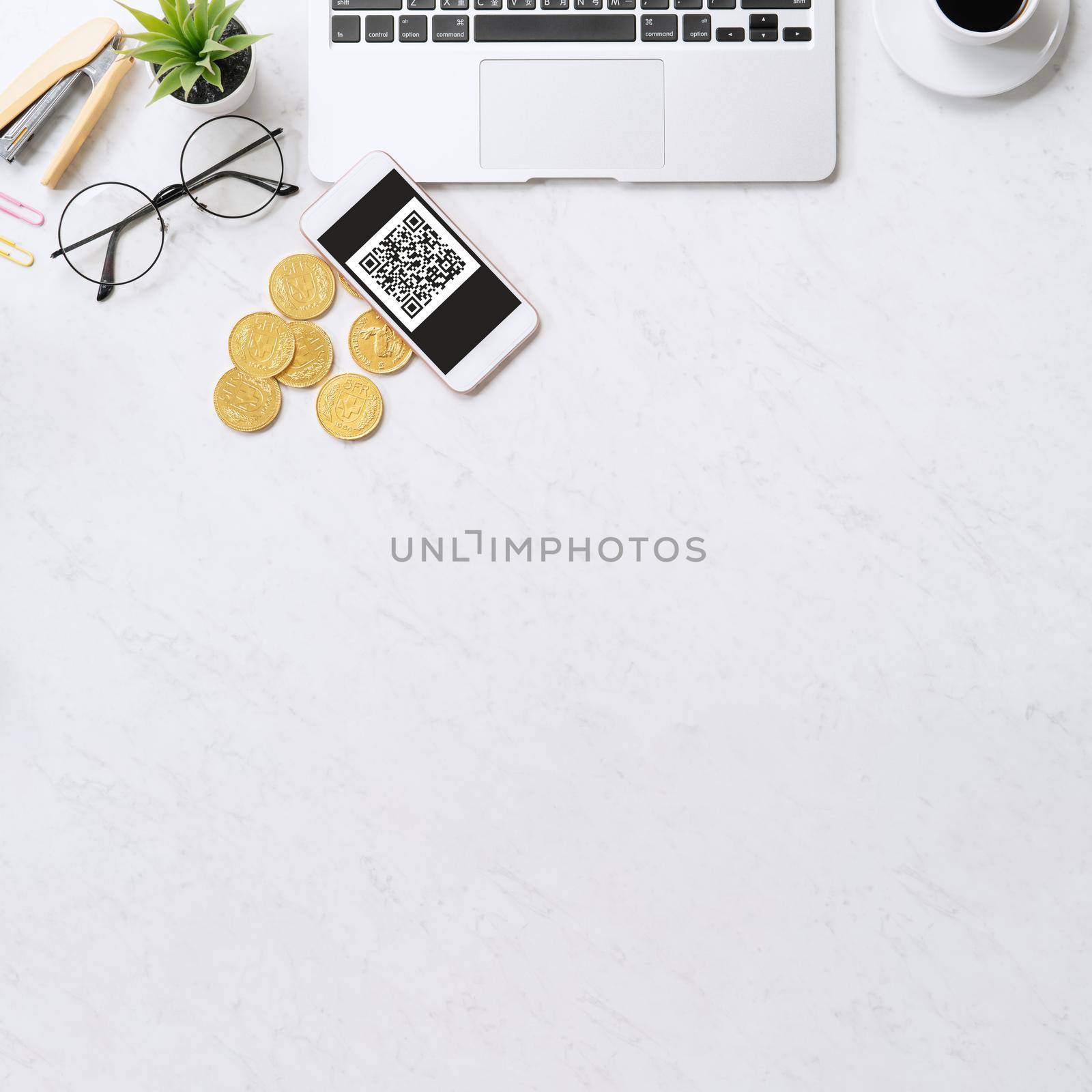 Online payment with QR code concept, virtual credit card, smart phone on office laptop desk on clean marble table background, top view, flat lay