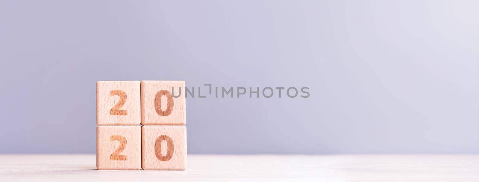 Abstract 2020, 2019 New year target plan design concept - wood blocks cubes on wooden table and pastel blue background, close up, blank copy space.