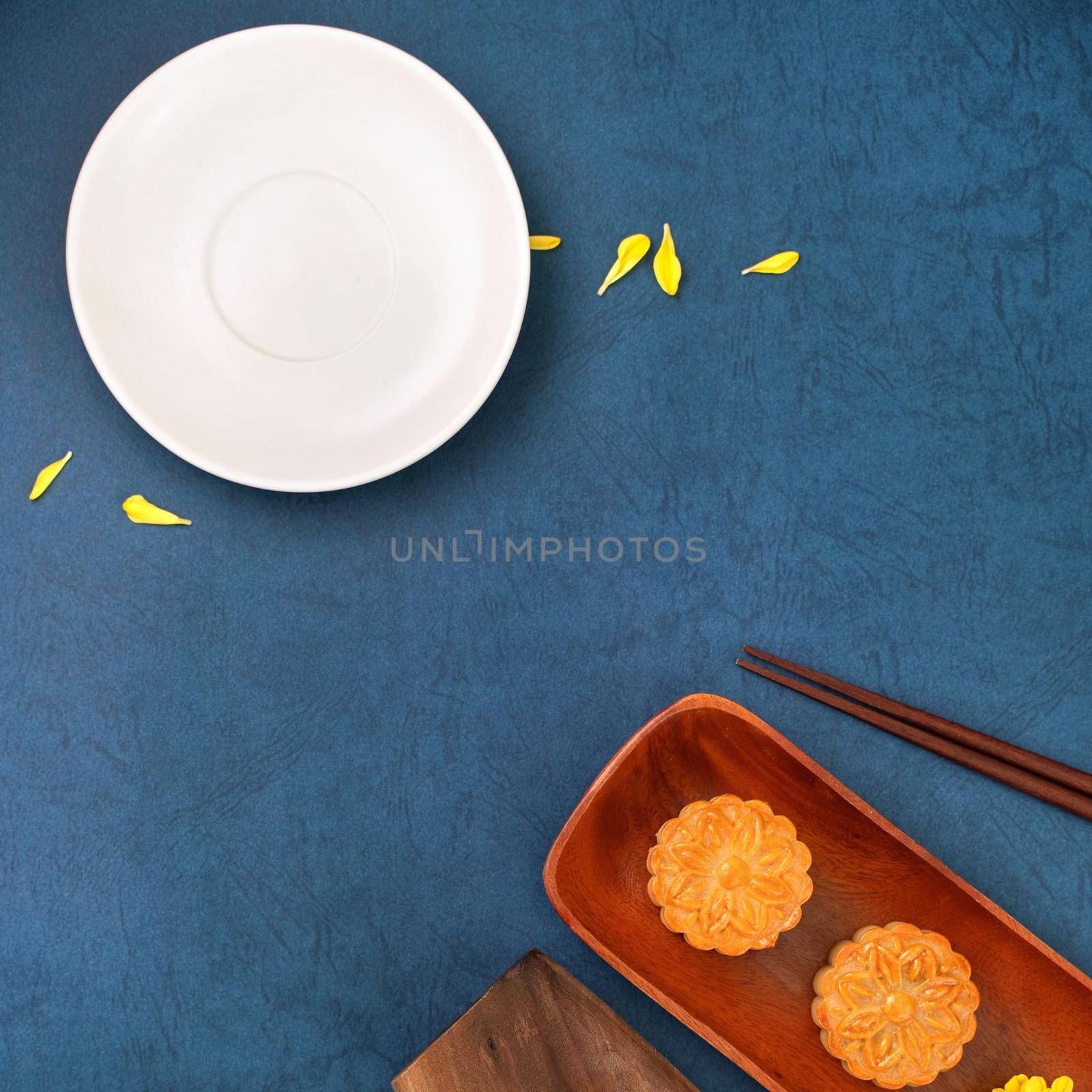 Minimal simplicity layout moon cakes on blue background for Mid-Autumn Festival, creative food design concept, top view, flat lay, copy space. by ROMIXIMAGE