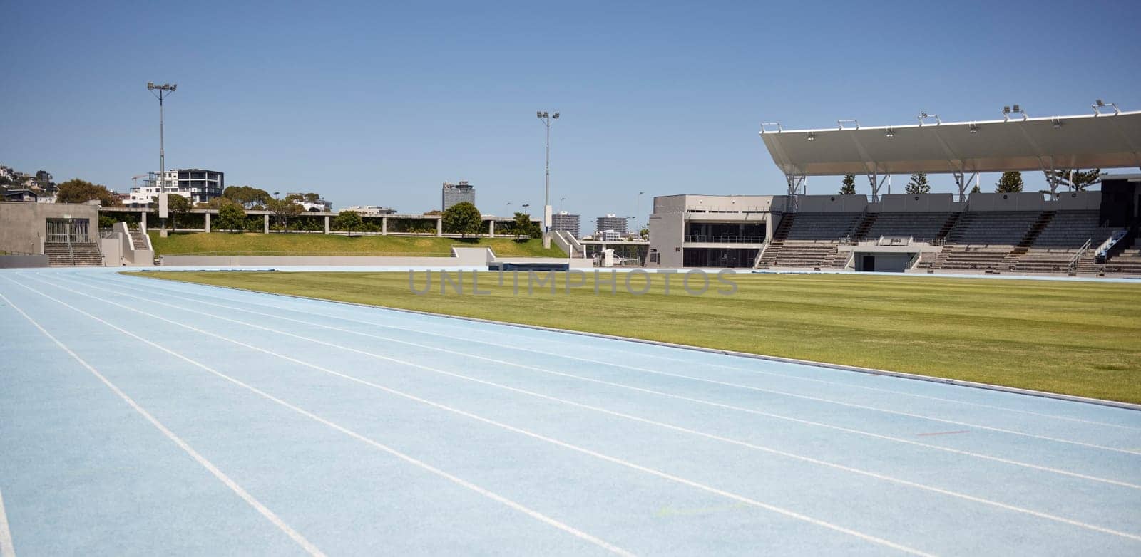 Race track, athletic and empty outdoor sports stadium for marathon, competition or olympics. Sport, no people and field at outside arena for training, exercise or workout for professional athletes