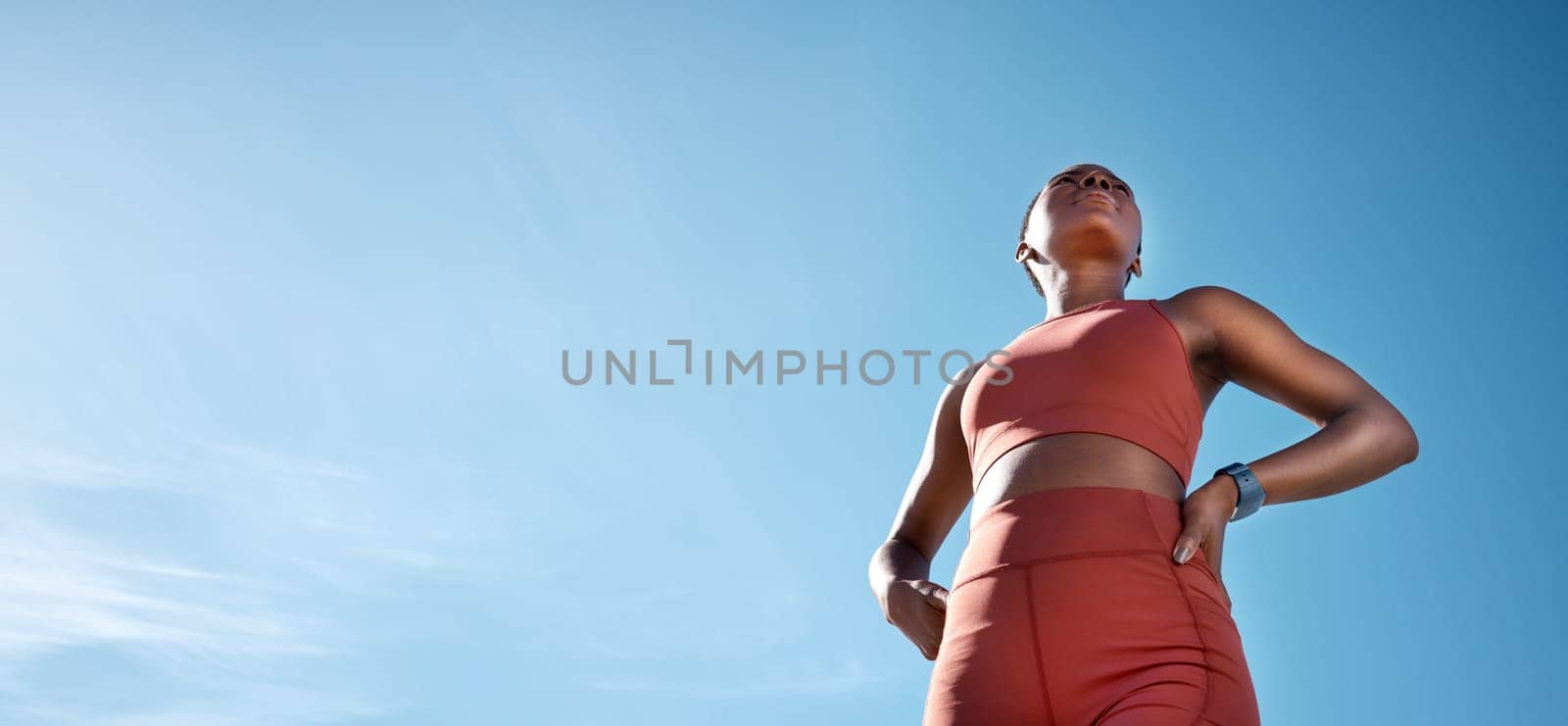 Fitness, black woman and blue sky, mockup and background of vision, mindset and motivation for exercise goals, healthy lifestyle or body wellness. Low angle, female sports athlete and outdoor mock up.