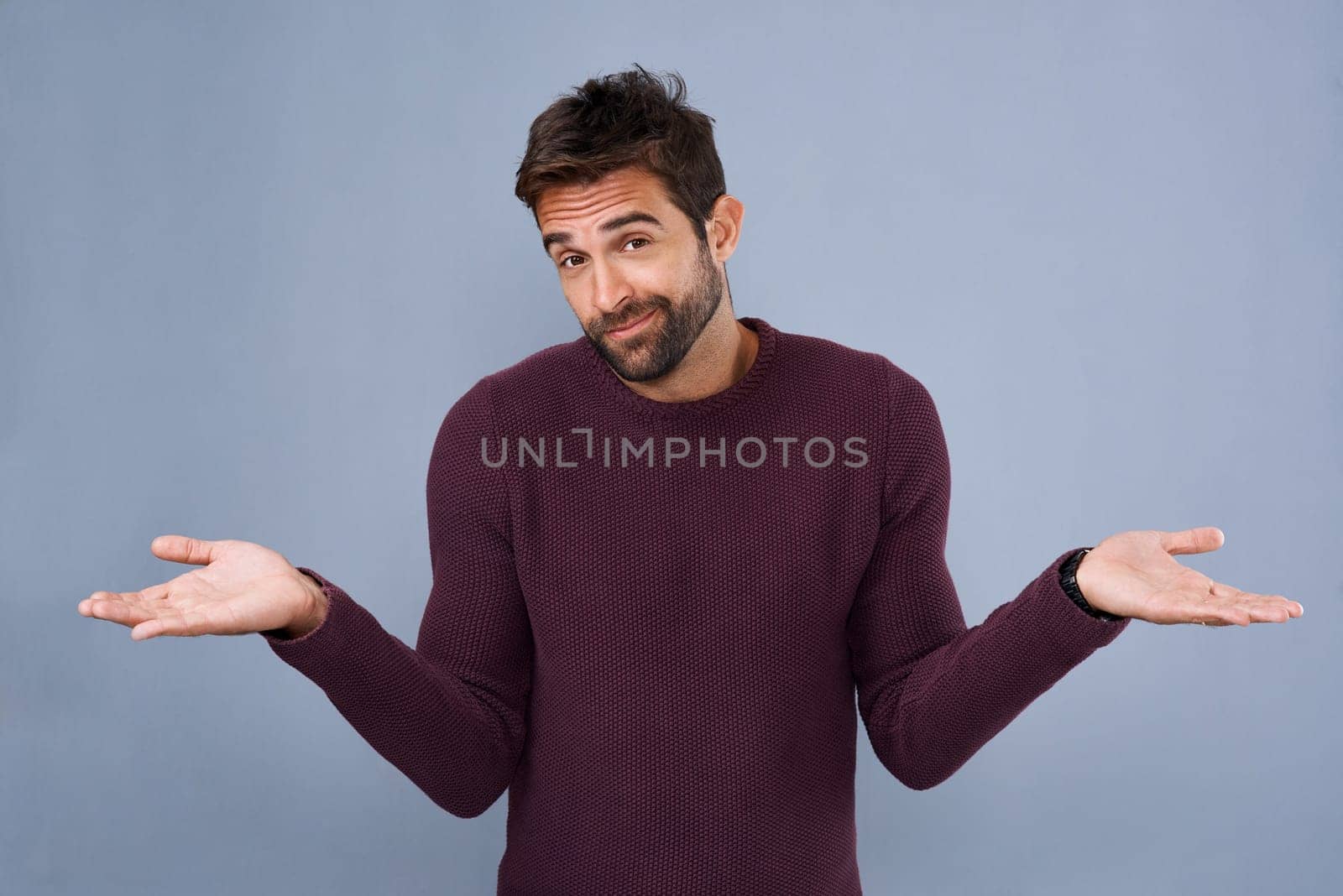 You win some, you lose some. Studio shot of a handsome young man gesturing in indifference against a gray background