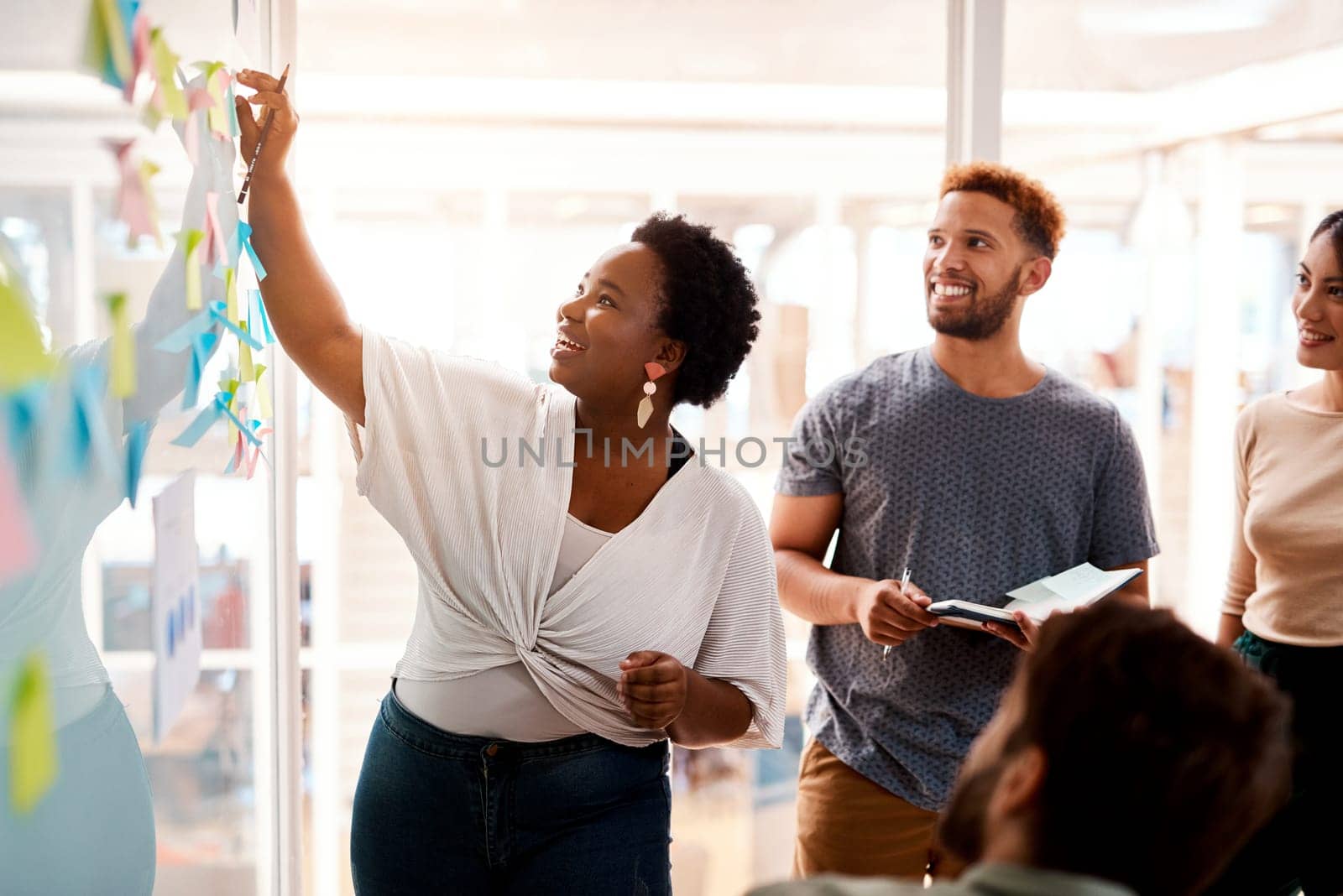 Coming up with stellar solutions. a young businesswoman brainstorming with her colleagues in an office