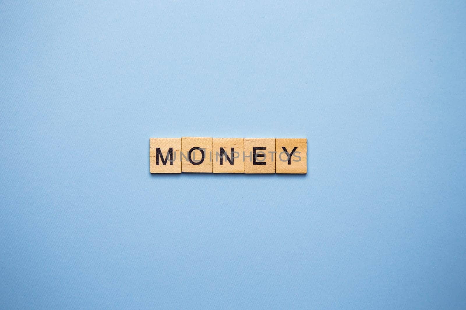 Finance concept. On a blue surface, wooden cubes with the inscription money