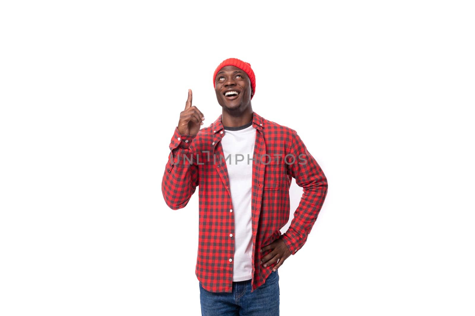 handsome joyful dark-skinned man in a casual plaid shirt of a model appearance with inspiration wants to communicate an idea on a white background with copy space by TRMK
