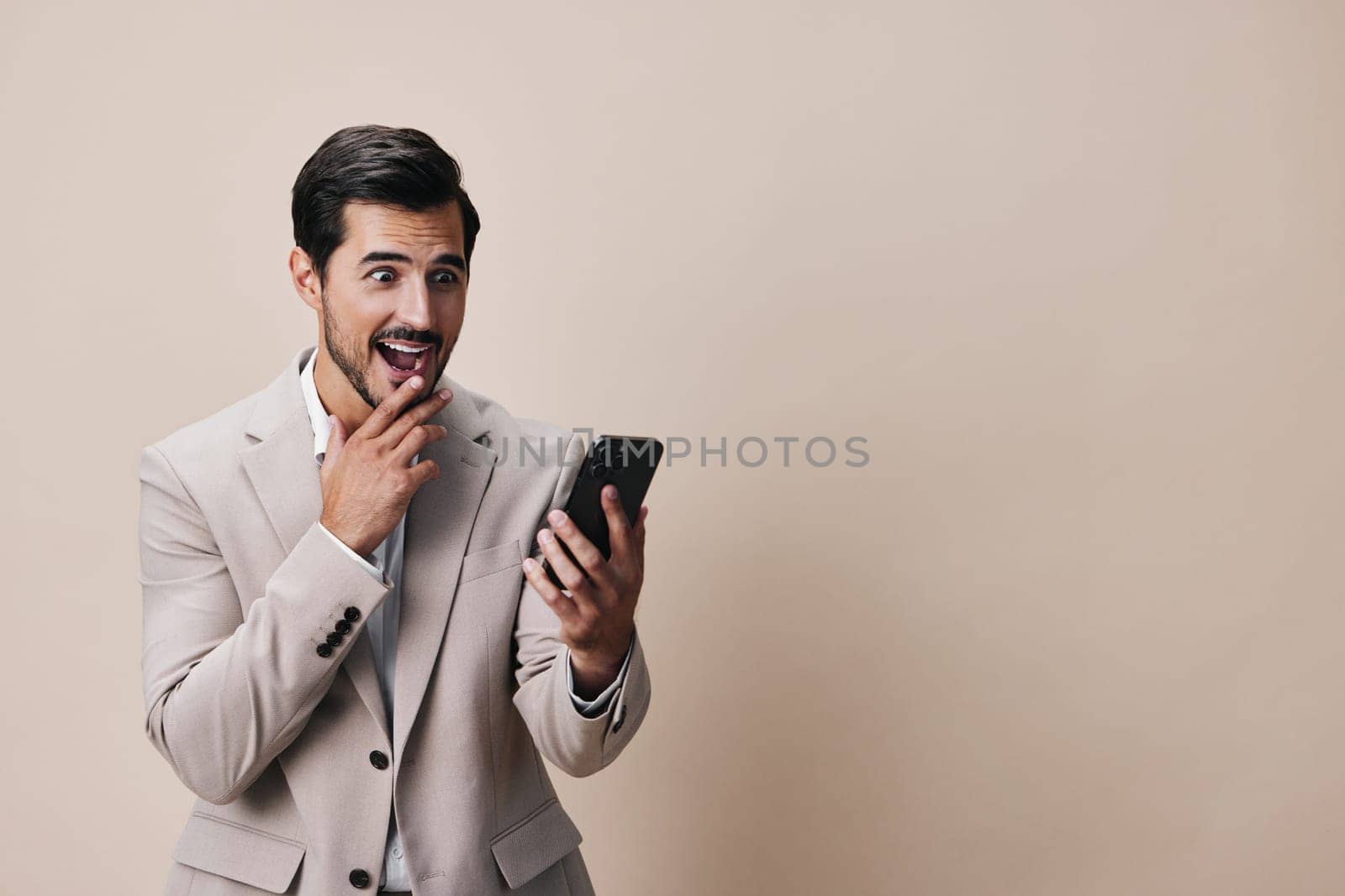 man communication happy suit gray lifestyle technology call beard phone smartphone cellphone young hold beige smile portrait white business guy confident