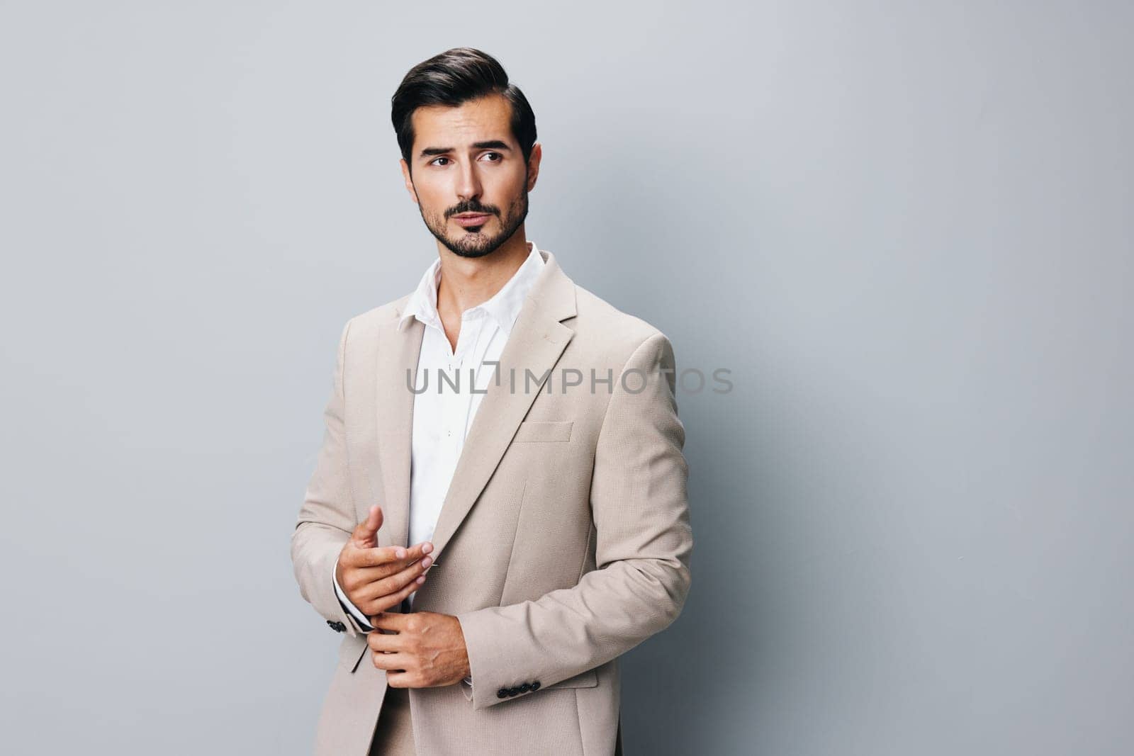 man sexy suit handsome arm smiling beige happy corporate business young posing occupation portrait guy businessman copyspace beard folded tie background