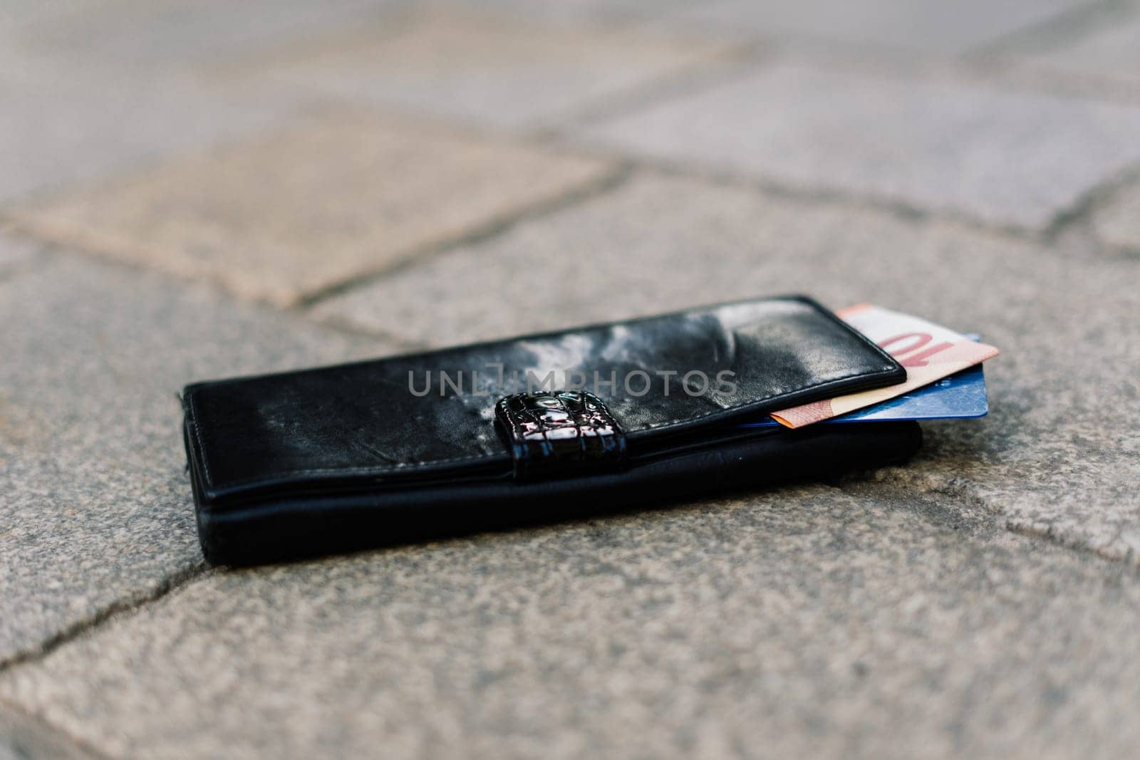 The wallet with coins on sidewalk street, forgotten money by Zelenin