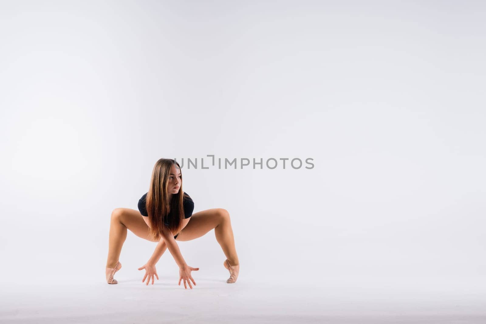 Beautiful cool young fit gymnast woman in sportswear dress working out, performing art gymnastics by Zelenin