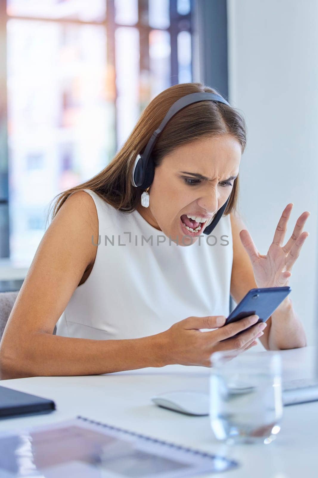 Angry, glitch and call center employee on a phone with bad news, communication and email stress. Telemarketing, contact us and frustrated woman reading a mistake, problem or chat fail on a mobile.