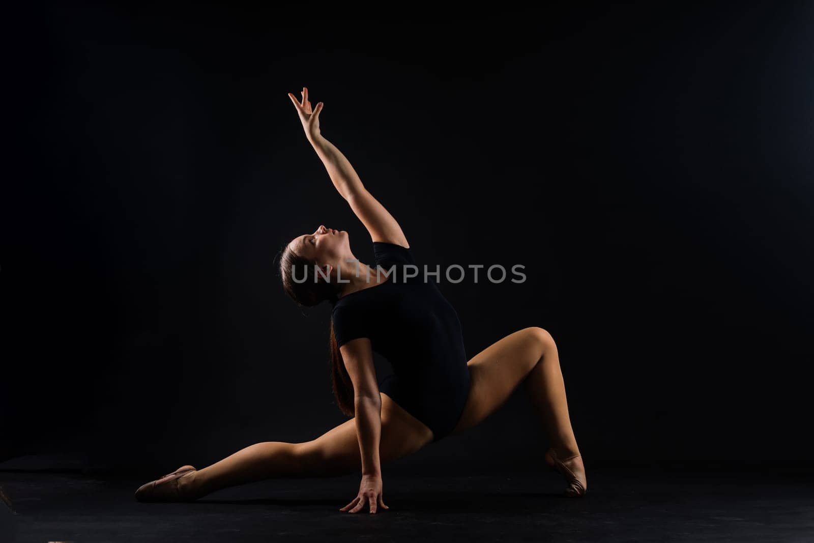 Beautiful cool young fit gymnast woman in a sportswear dress working out, performing art gymnastics