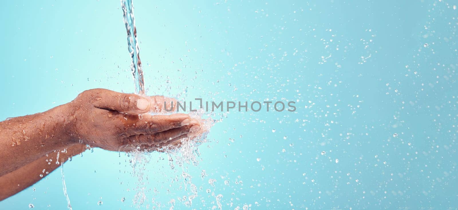 Water stream, splash and black hands with mockup for cleaning and morning hand cleaning. Blue background, mock up and person with skincare, sustainable dermatology and clean health safety in studio.