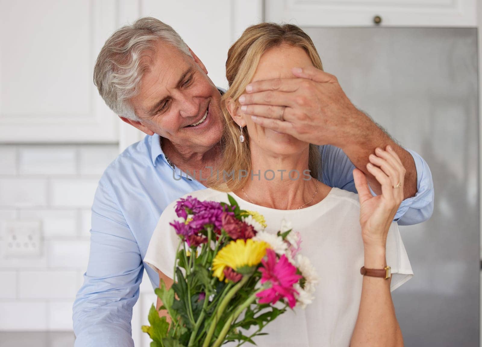 Senior couple covering eyes for flowers surprise, anniversary love and valentines day in New Zealand home. Happy man giving bouquet to woman for birthday gift, present and celebrate romance together.