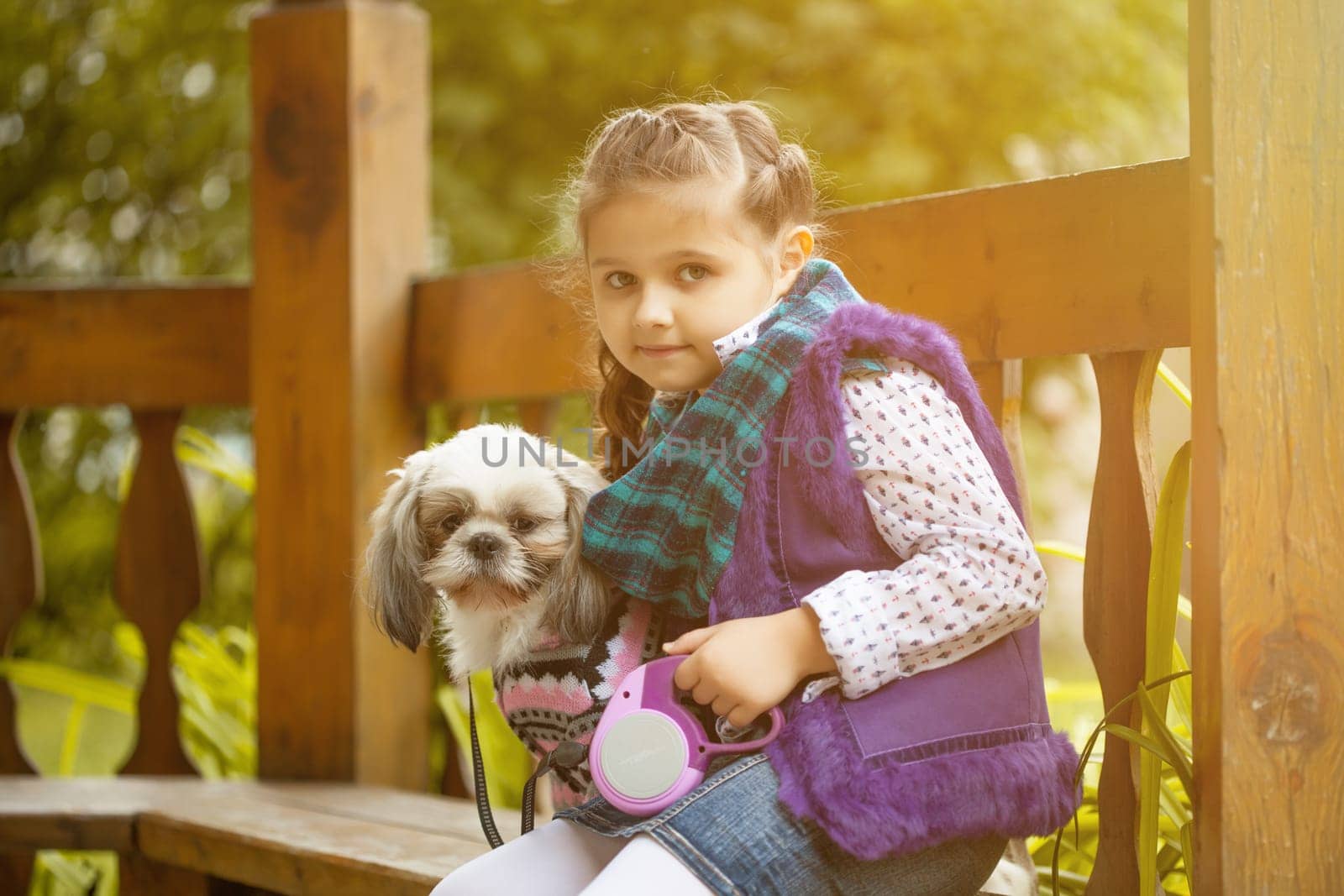 Image of pretty little girl posing with cute dog, close-up