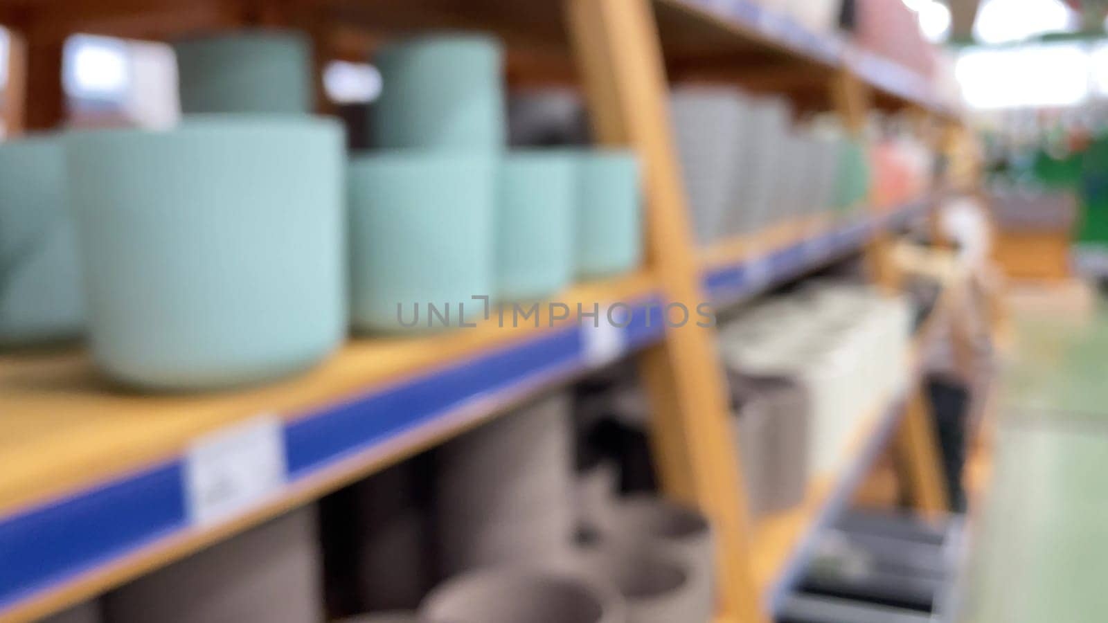 Close-up of empty flower pots in a store or greenhouse. Colorful pots for plants. Gardening and landscape design concept by Matiunina