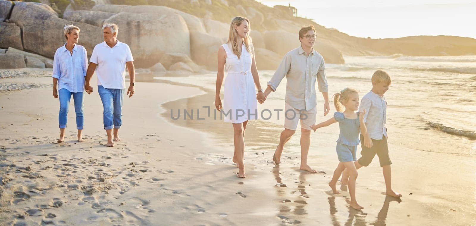 Family generations, walking and beach with sunset for men, women and children with love on holiday. Parents, grandparents and kids by ocean, holding hands and bond on summer vacation with solidarity by YuriArcurs