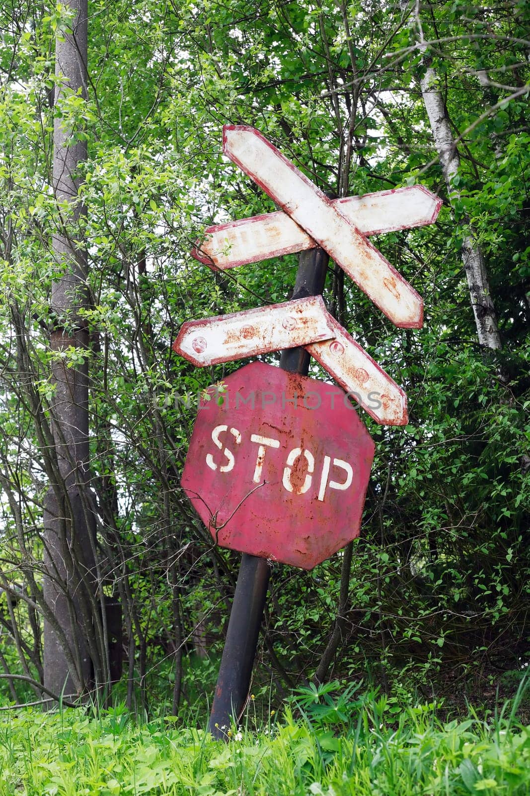 Sign STOP for train. An abandoned old railway in the middle of the forest