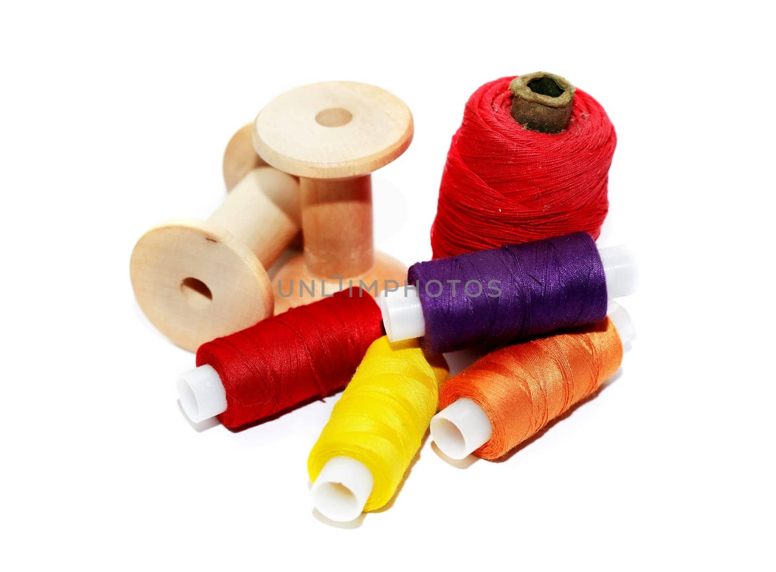 A set of multicolored threads on a white background