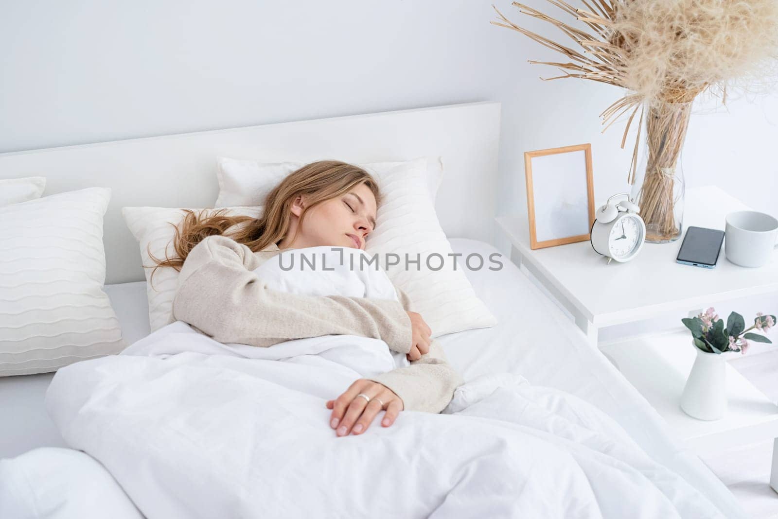 caucasian Woman sleeping at bed at home. young millennial woman sleeping, morning light on the bed