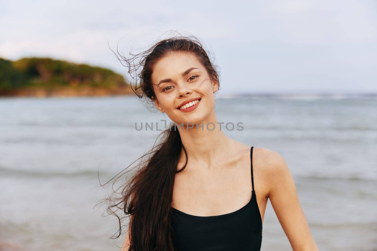 sky woman beach carefree vacation beauty summer adult sand sea walking sunset beautiful smiling outdoor long ocean smile lifestyle coast hair freedom