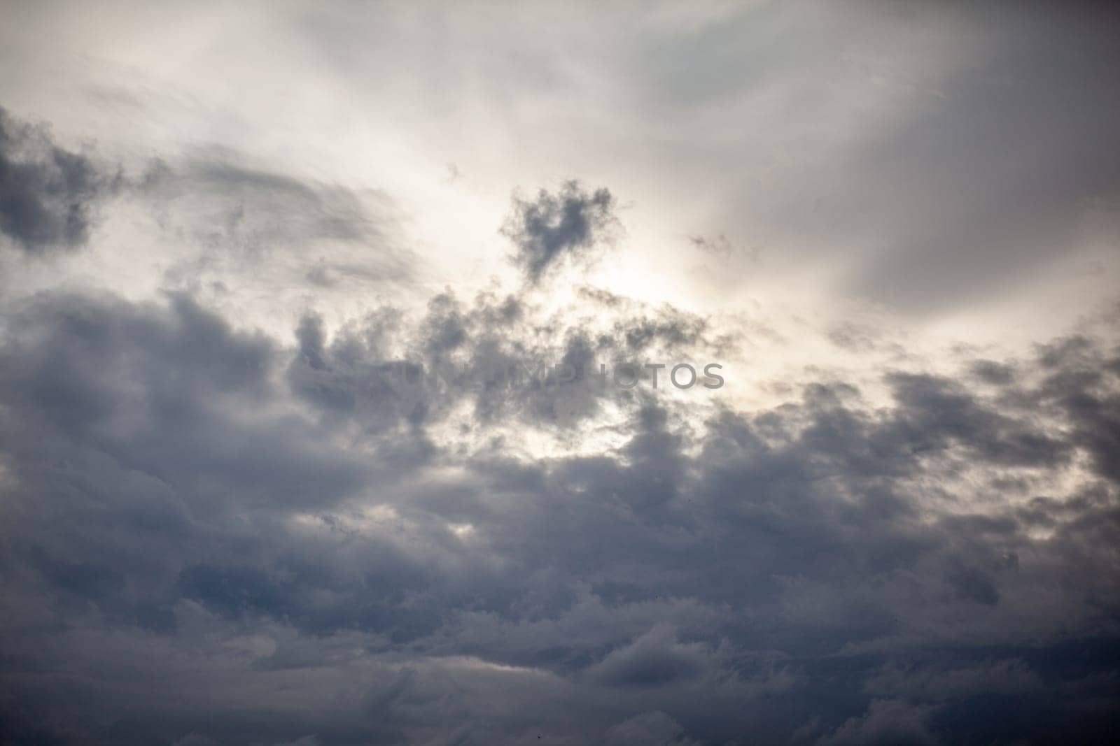 Dramatic sky with grey clouds over the city before the storm. Weather before or after a storm.