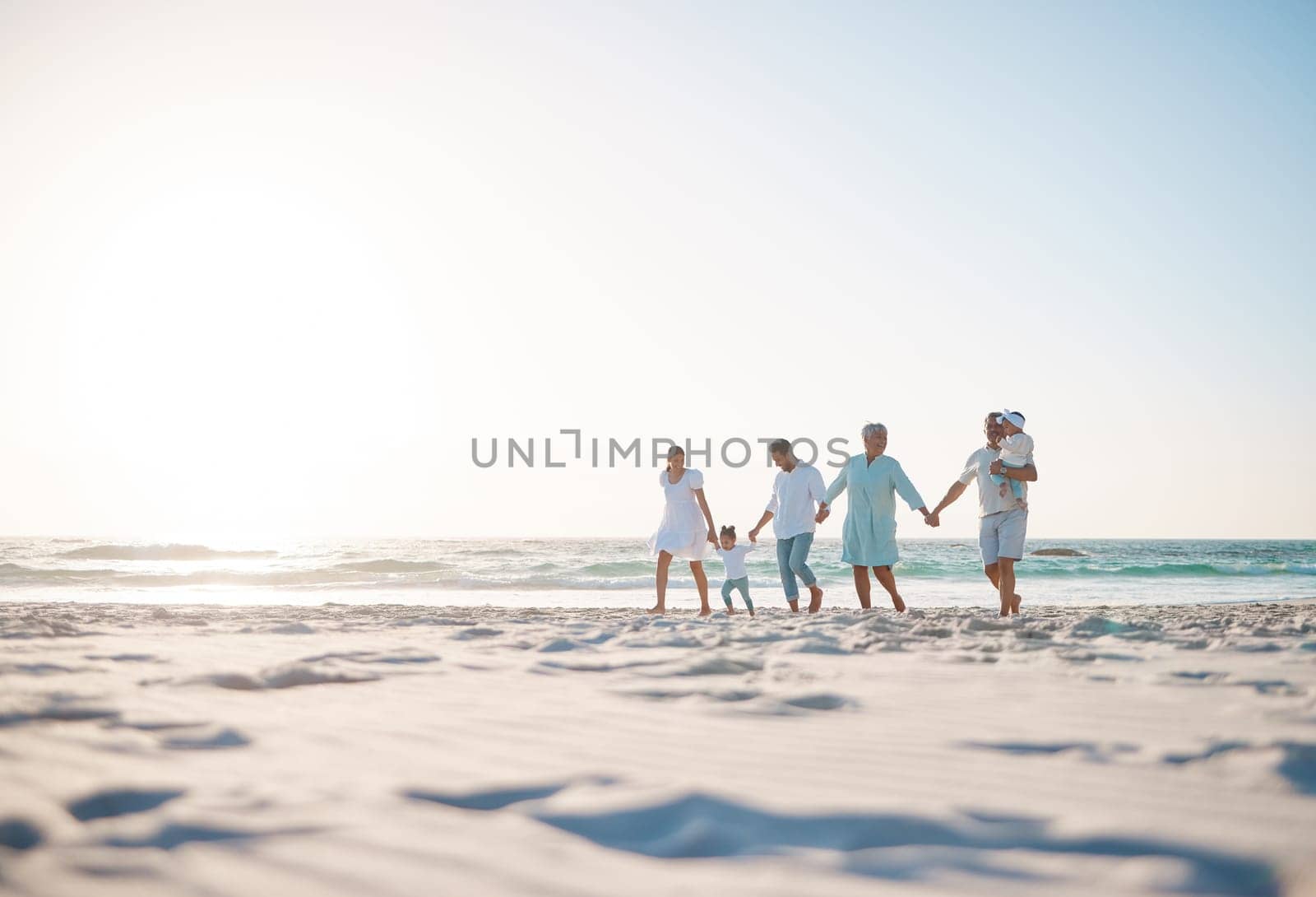 Big family, holding hands and holiday on beach with mockup space for weekend or vacation. Grandparents, parents and kids walking together on the ocean coast for fun bonding or quality time in nature.