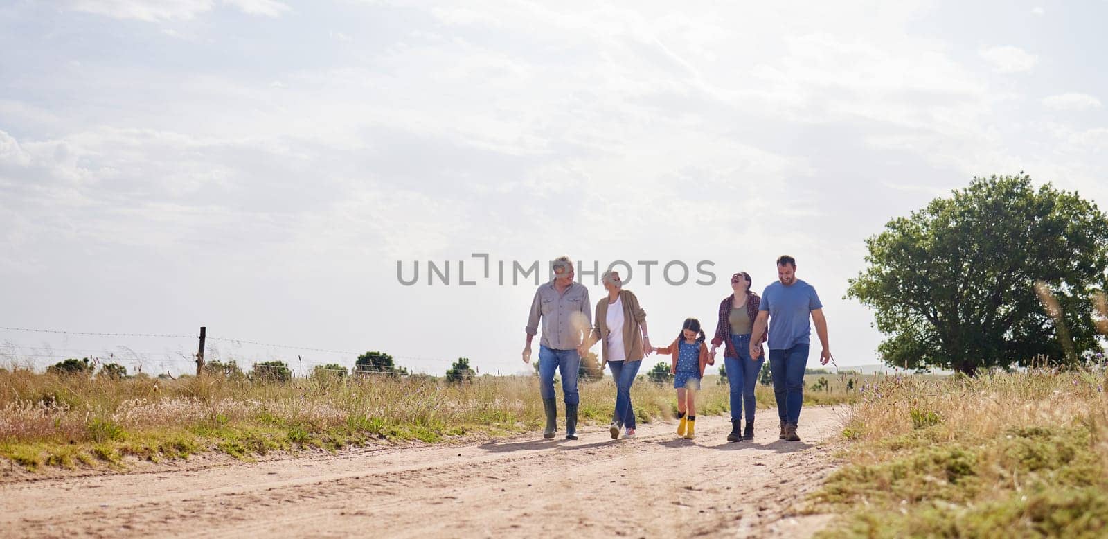 Love, happy family walking holding hands and on a farm with blue sky. Support or care, happiness or agriculture and people walk outdoors by countryside or rural environment together with generation.