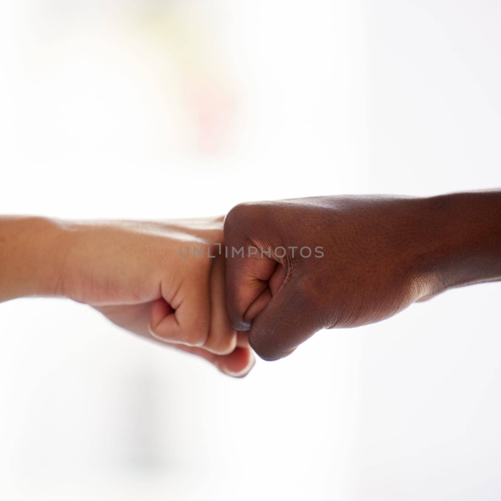 Diversity, fist bump and hands of people in support of power, solidarity and collaboration against white background. Hands, connection and men friends in partnership with trust, teamwork or equality by YuriArcurs