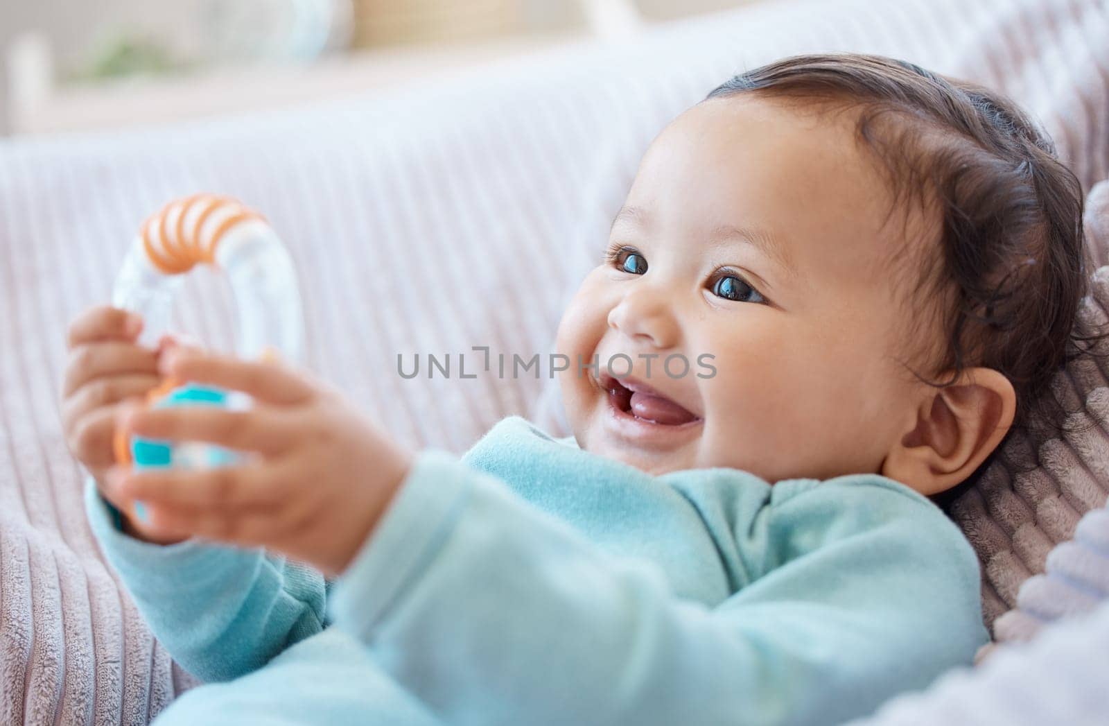 Happy baby, rattle and child in bedroom for childhood development, growth and cute smile at home. Adorable young girl, infant kid and playing with toys for happiness, fun and relax in nursery room by YuriArcurs