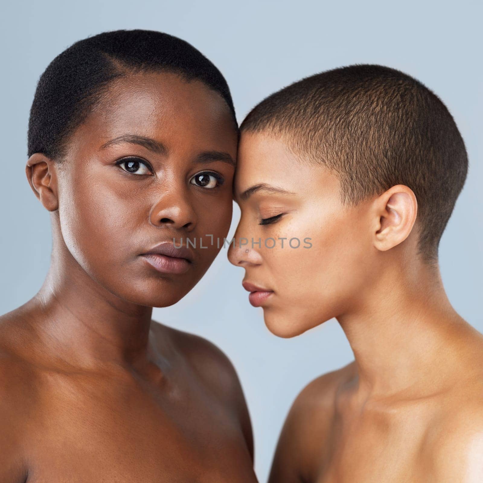 Our love is like no other. Portrait of two beautiful young women standing close to each other against a grey background